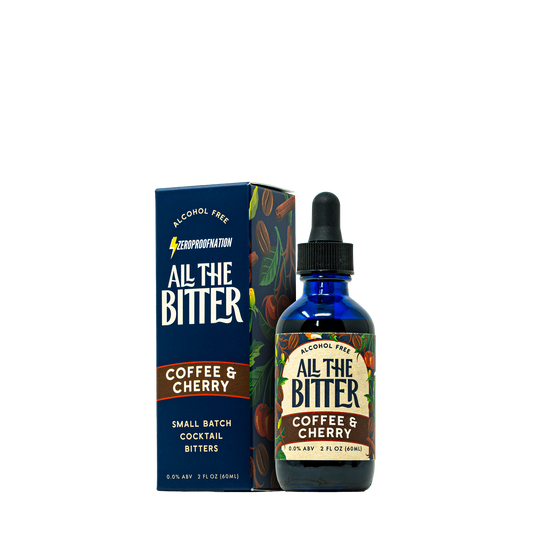 A bottle of All The Bitter Coffee & Cherry alcohol-free cocktail bitters next to its dark blue packaging box, featuring a cobalt blue glass bottle with a black dropper cap and a colorful label.