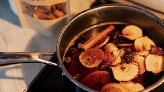 Mulled wine kit on stove with apple, clove, cinnamon, star anise